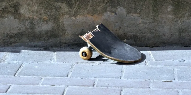 A damaged skateboard symbolizing persistence, risk, and repeated setbacks