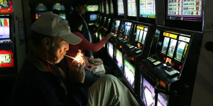 A person lights a cigarette inside a casino as the debate over indoor smoking in Atlantic City continues